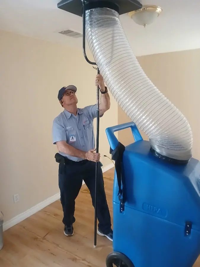 Furnace Tune-Up technician using HEPA equipment in Asbury Lake